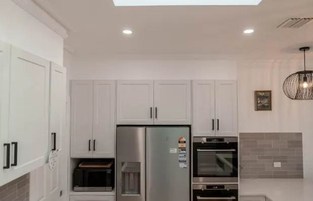 Dornford custom home — white kitchen with skylights
